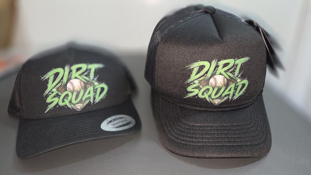 Two finished Dirt Squad custom snapback hats printed by Casual Comforts LLC